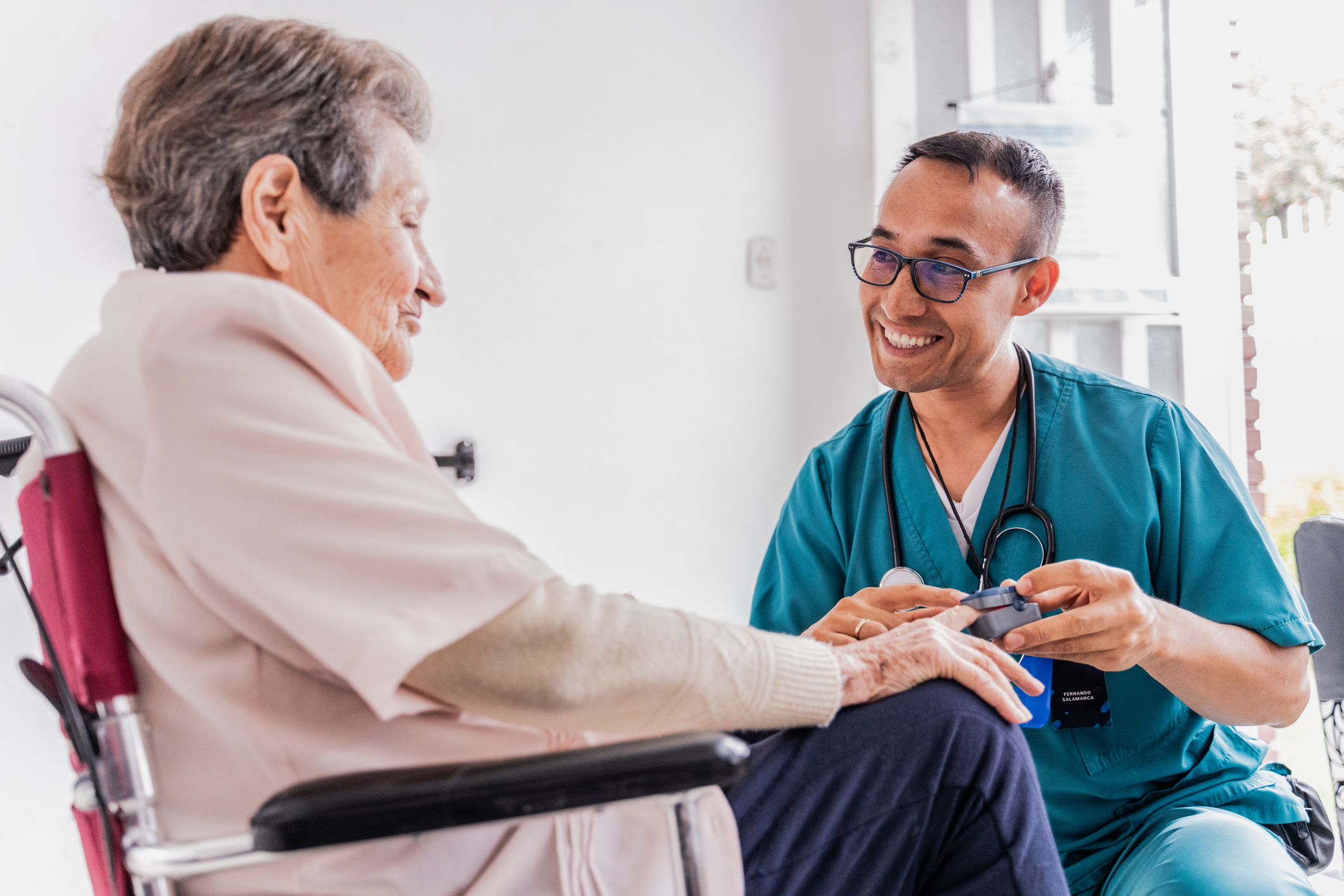 Nurse taking vitals of an elderly patient